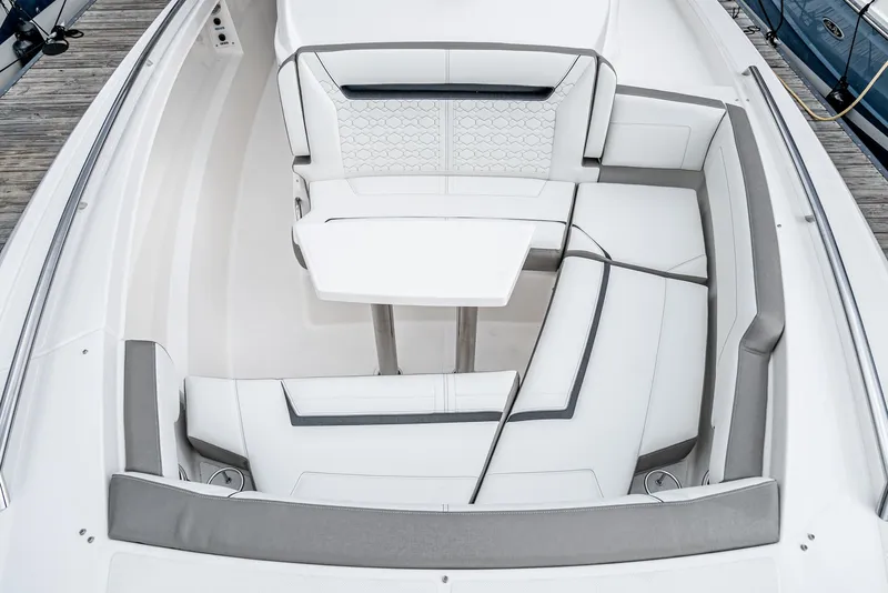 Slide: The Image of 2024 Tiara Yachts 34LS boat interior with white and gray seating and table. - 10