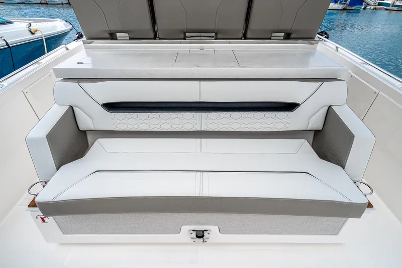 Slide: The Image of 2024 Tiara Yachts 34LS luxury boat seating area with white and gray upholstery. - 31