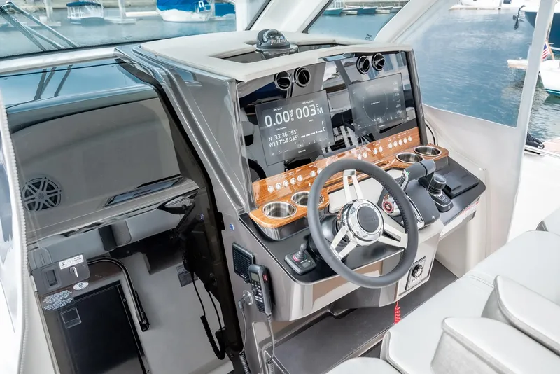 Slide: The Image of 2024 Tiara Yachts 34LS helm station with modern navigation displays and controls. - 39