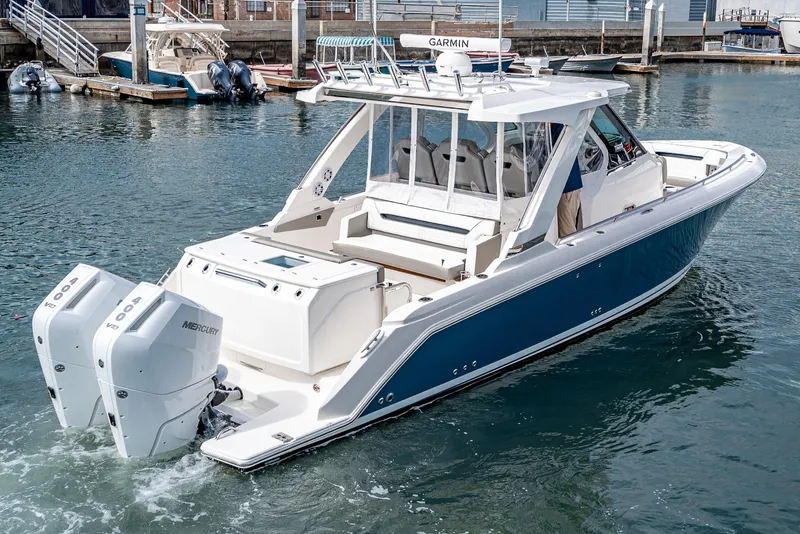Slide: The Image of 2024 Tiara Yachts 34LS with twin Mercury outboard engines docked in marina. - 4