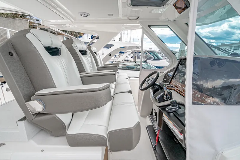 Slide: The Image of 2024 Tiara Yachts 34LS interior cockpit with luxurious seating and advanced helm controls. - 41