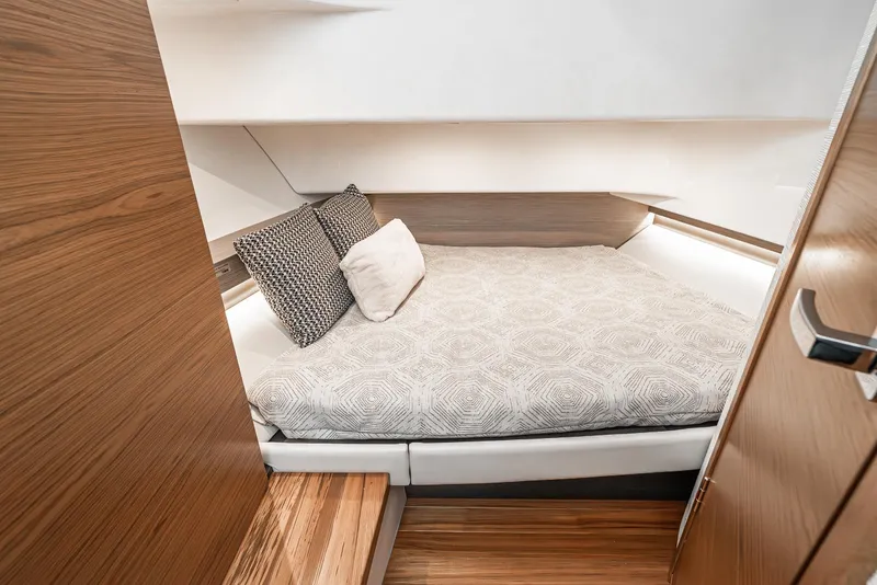 Slide: The Image of 2024 Tiara Yachts 34 LS cabin interior with cozy bed and modern design. - 49