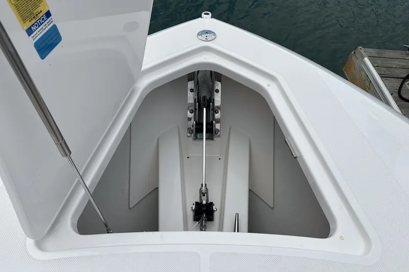 Slide: The Image of Anchor compartment of 2024 Tiara Yachts 34LS, open hatch, dockside view. - 7