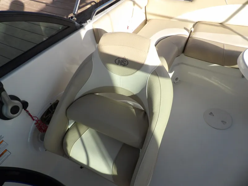 Slide: The Image of 2018 NauticStar 203DC Sport Deck boat interior with beige seating. - 14