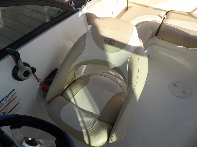 Slide: The Image of 2018 NauticStar 203DC Sport Deck boat interior with beige captain's chair. - 15