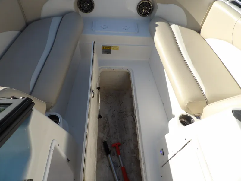Slide: The Image of 2018 NauticStar 203DC Sport Deck boat interior with open storage compartment. - 24