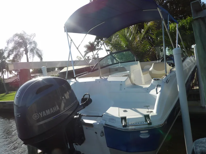 Slide: The Image of 2018 NauticStar 203DC Sport Deck boat with Yamaha outboard motor docked. - 6