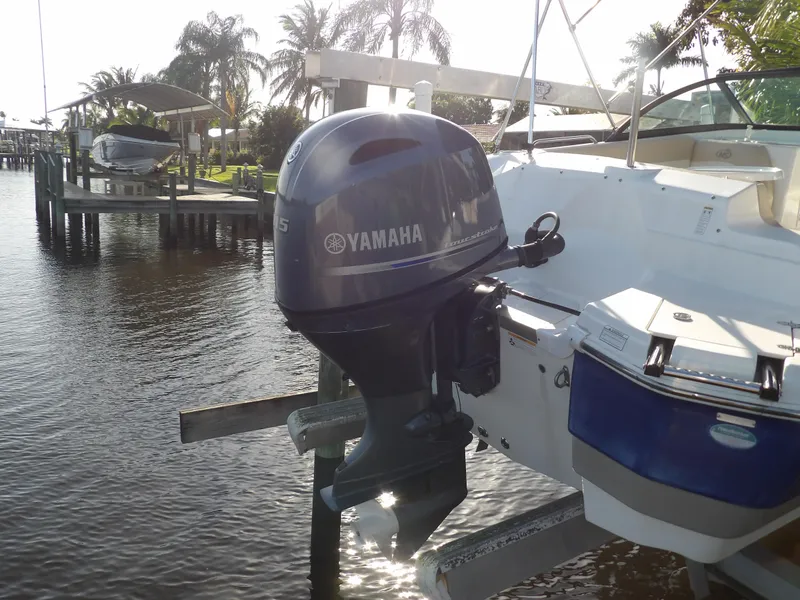 Slide: The Image of 2018 NauticStar 203DC Sport Deck with Yamaha outboard motor on a dock. - 7