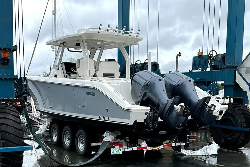 Slide: The Image of 2022 Pursuit S 328 Sport boat on trailer with dual outboard engines. - 11