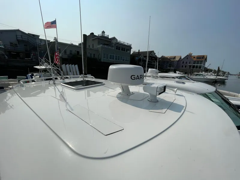 Slide: The Image of 2022 Pursuit S 328 Sport boat docked with Garmin radar and American flag. - 25