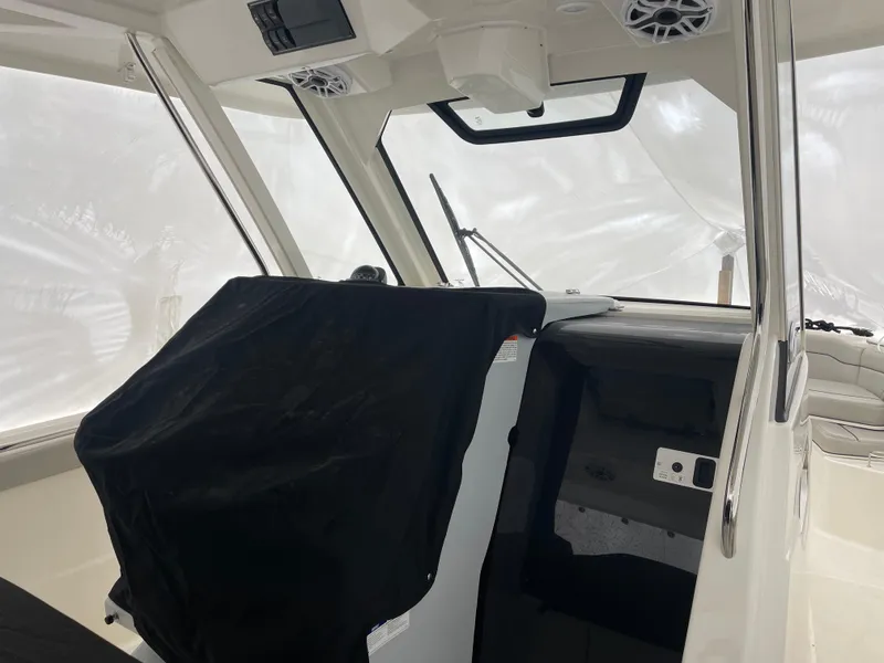 Slide: The Image of Interior of 2022 Pursuit S 328 Sport boat with covered dashboard and modern design. - 32