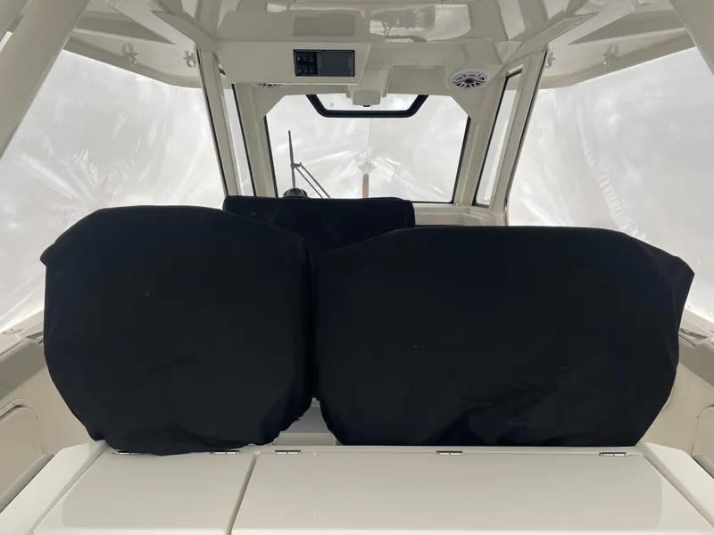 Slide: The Image of Interior of 2022 Pursuit S 328 Sport boat with covered seats. - 35