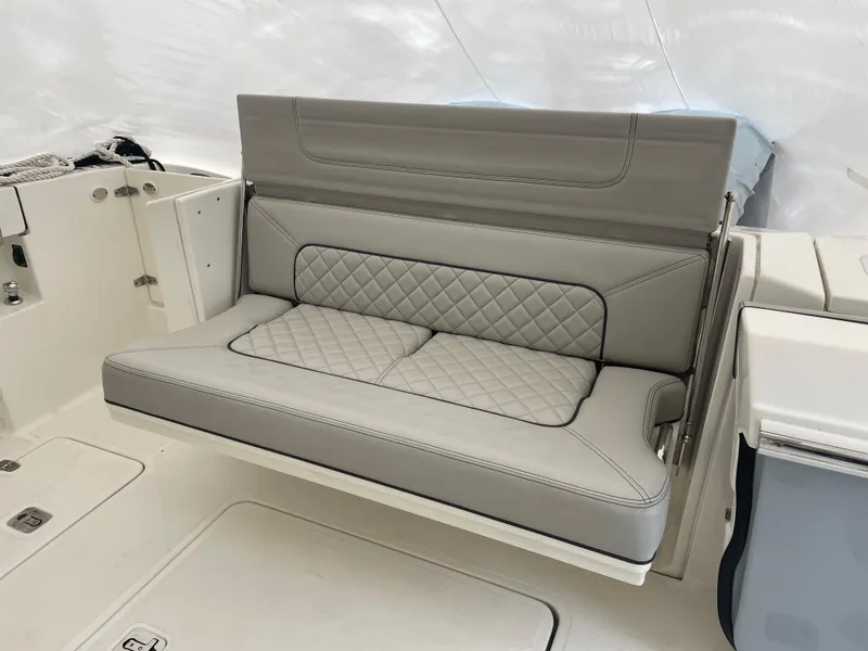 Slide: The Image of 2022 Pursuit S 328 Sport boat with luxurious gray quilted seating. - 48