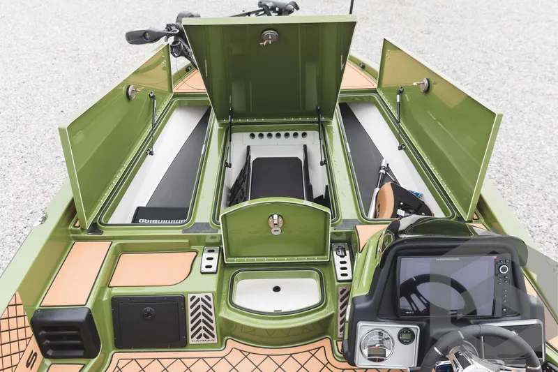 Slide: The Image of 2024 Caymas XS 20 Pro boat interior with open storage compartments and control panel. - 15