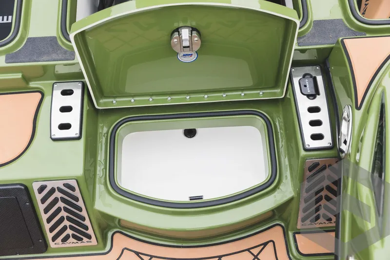 Slide: The Image of 2024 Caymas XS 20 Pro boat storage compartment with green and tan interior. - 19