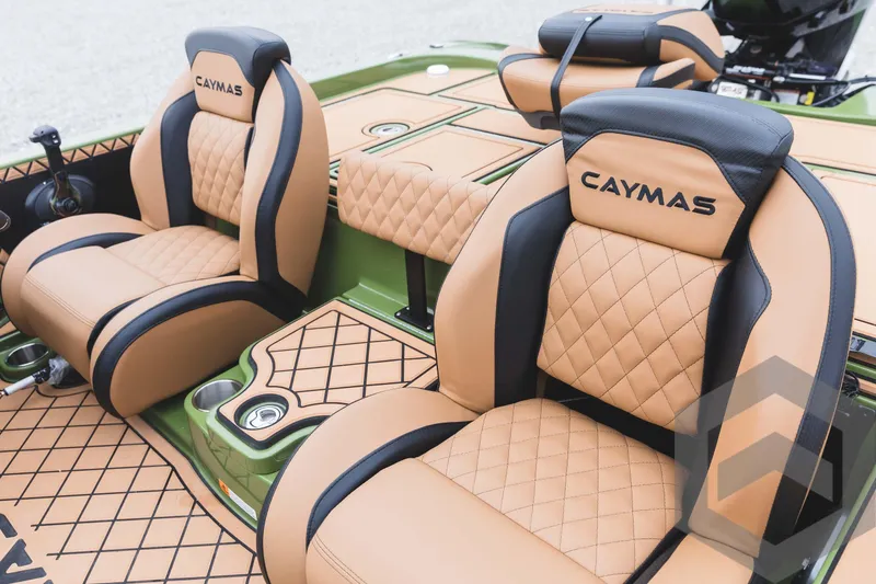 Slide: The Image of 2024 Caymas XS 20 Pro boat interior with tan and black diamond-stitched seats. - 24