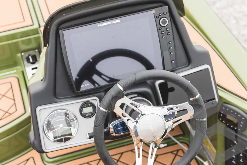 Slide: The Image of 2024 Caymas XS 20 Pro boat dashboard with steering wheel and electronic display. - 29