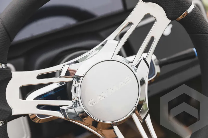 Slide: The Image of Close-up of 2024 Caymas XS 20 Pro steering wheel with chrome accents. - 30