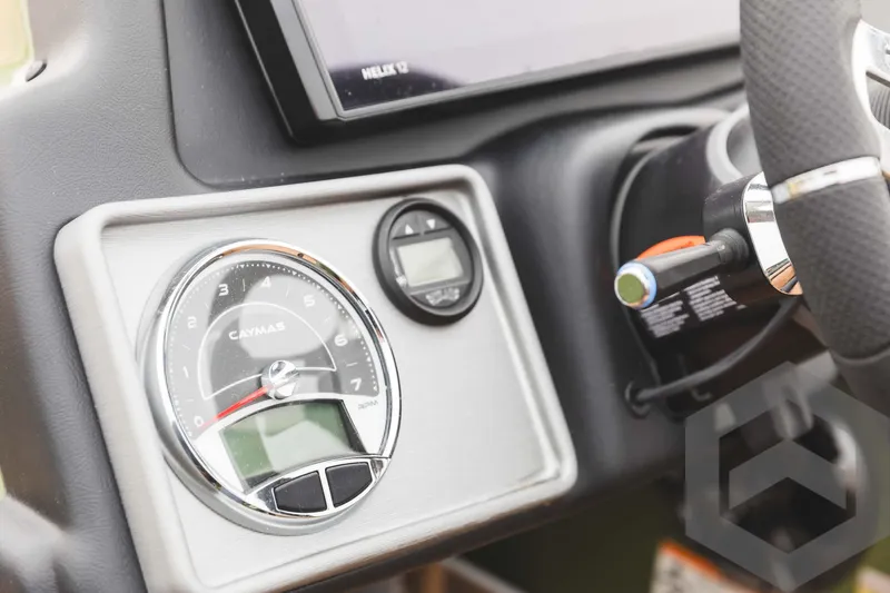 Slide: The Image of 2024 Caymas XS 20 Pro boat dashboard with gauges and steering wheel. - 31