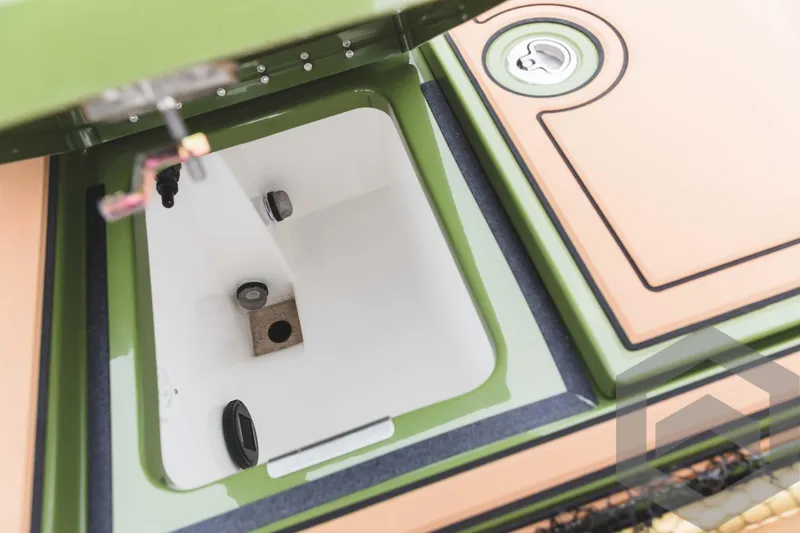 Slide: The Image of 2024 Caymas XS 20 Pro livewell compartment with green and tan accents. - 38