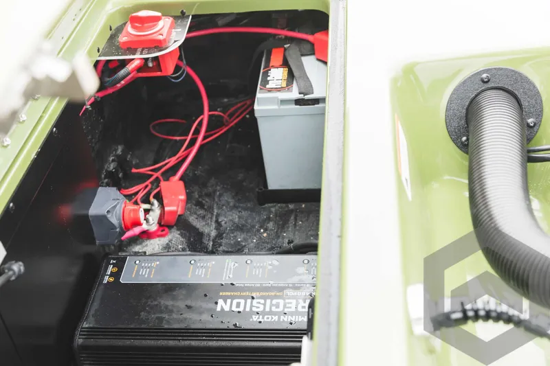 Slide: The Image of 2024 Caymas XS 20 Pro boat battery compartment with wiring and components. - 40