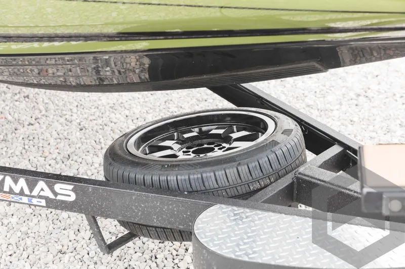 Slide: The Image of 2024 Caymas XS 20 Pro trailer with spare tire on gravel. - 46