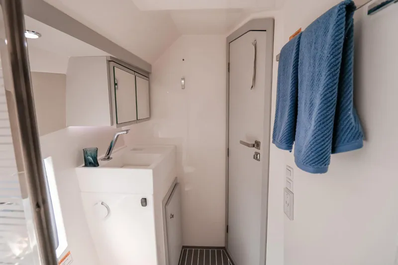 Slide: The Image of Modern bathroom interior in 2021 Evolve 400HT, featuring sleek design and blue towel accents. - 12