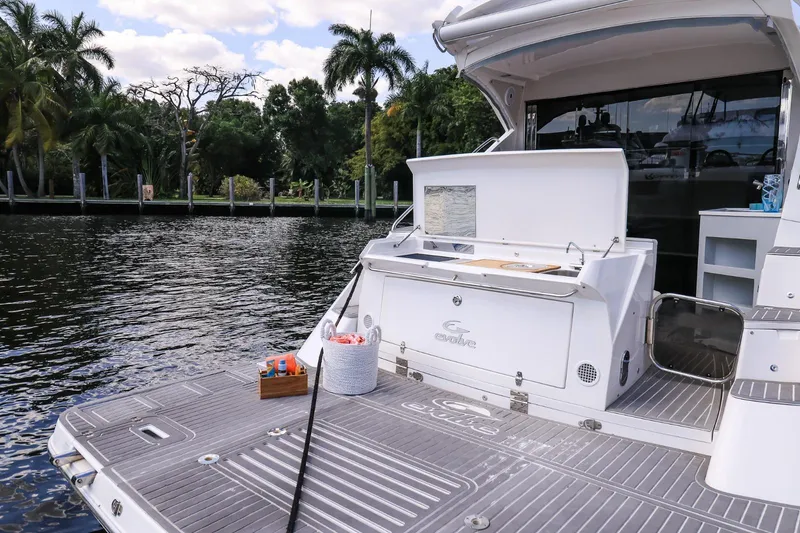 Slide: The Image of Luxury Evolve 400HT yacht docked by a scenic waterfront, 2021 model. - 16