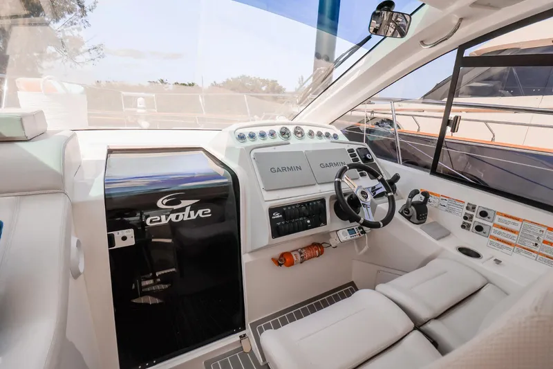 Slide: The Image of 2021 Evolve 400HT yacht cockpit with modern navigation equipment and comfortable seating. - 19