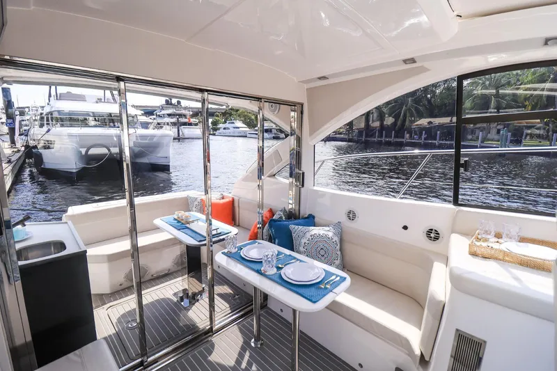 Slide: The Image of Luxurious 2021 Evolve 400HT yacht interior with elegant dining setup and waterfront view. - 20