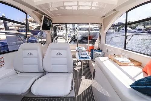 Slide: The Image of Interior of 2021 Evolve 400HT yacht with luxurious seating and dining area. - 23