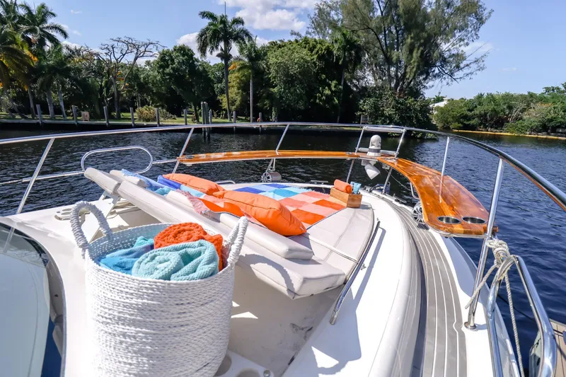 Slide: The Image of Luxurious 2021 Evolve 400HT yacht with sunbathing deck and vibrant towels on a scenic river. - 29