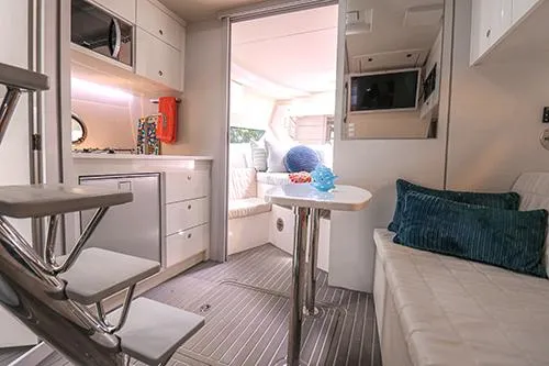 Slide: The Image of Modern interior of 2021 Evolve 400HT yacht with cozy seating and sleek kitchen area. - 9