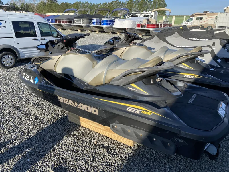 Slide: The Image of 2017 Sea-Doo GTX 155 jet ski in a marina, parked on gravel. - 4