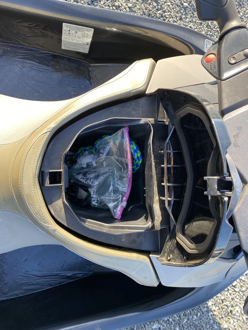 Slide: The Image of 2017 Sea-Doo GTX 155 storage compartment with items inside. - 7