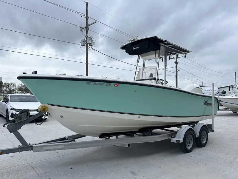 Slide: The Image of 2014 Mako 204 CC boat on trailer, light blue hull, center console. - 3