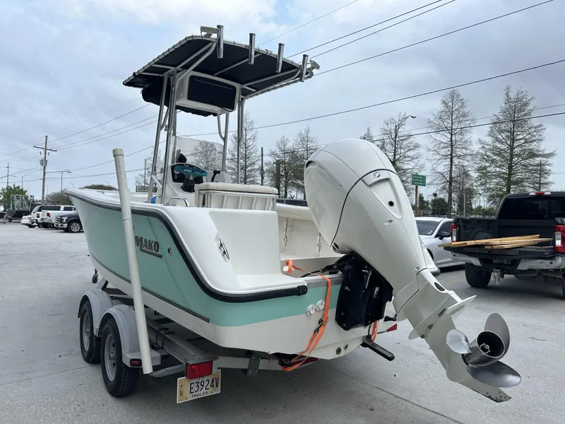 Slide: The Image of 2014 Mako 204 CC boat on trailer with outboard motor in parking lot. - 8