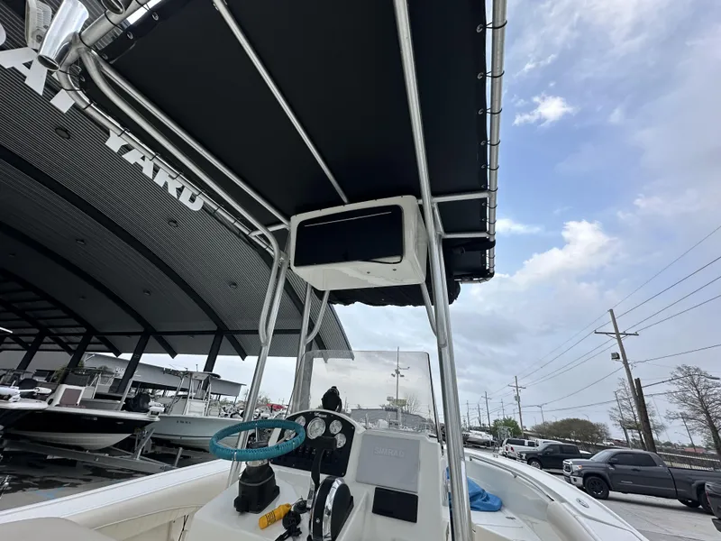Slide: The Image of 2014 Mako 204 CC center console boat with T-top and steering wheel. - 9