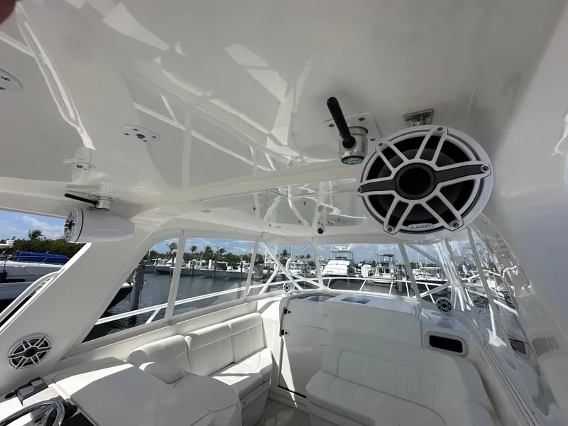 Slide: The Image of Interior of a 2008 Intrepid 390 Sport Yacht with white seating and marine speakers. - 14