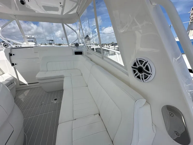Slide: The Image of Interior of 2008 Intrepid 390 Sport Yacht with white seating and panoramic windows. - 15