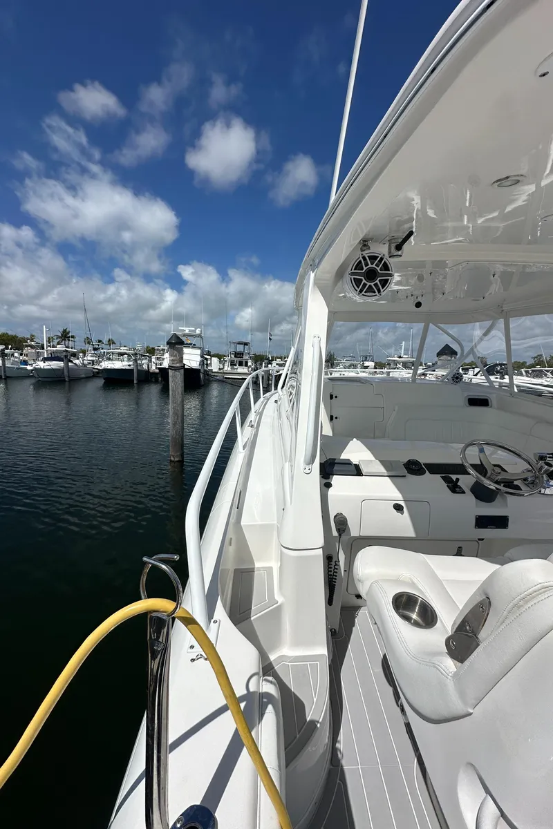 Slide: The Image of 2008 Intrepid 390 Sport Yacht docked at a marina under a clear blue sky. - 17