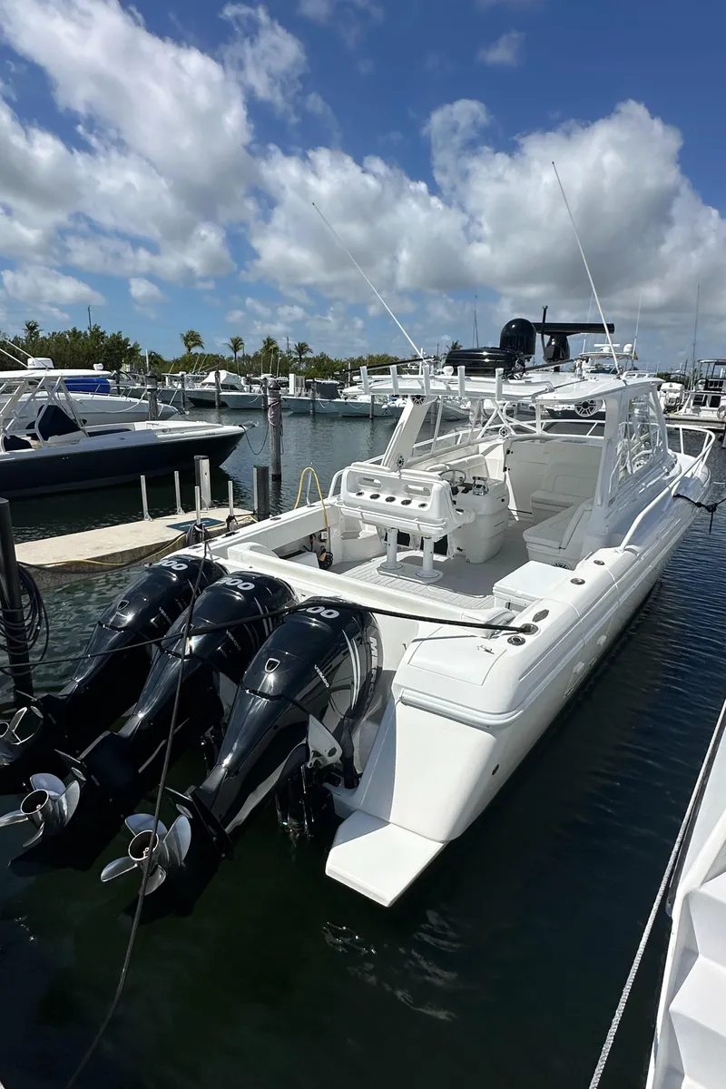 Slide: The Image of 2008 Intrepid 390 Sport Yacht docked at marina with triple outboard engines. - 2