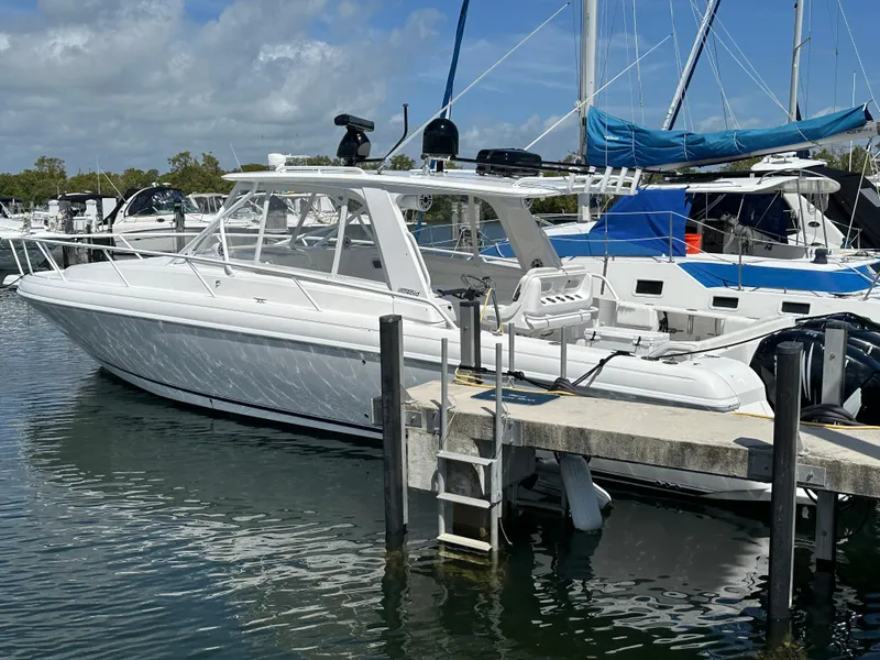 Slide: The Image of 2008 Intrepid 390 Sport Yacht docked at marina with sailboats in background. - 20