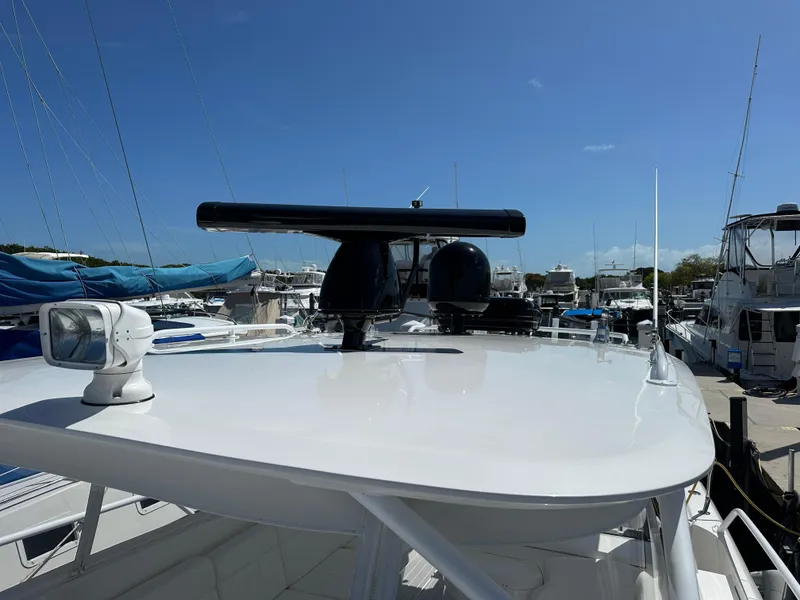 Slide: The Image of 2008 Intrepid 390 Sport Yacht at marina, showcasing radar and navigation equipment. - 3