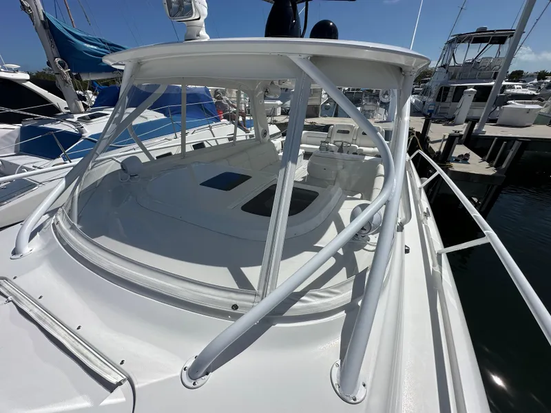 Slide: The Image of 2008 Intrepid 390 Sport Yacht docked at a marina, showcasing its sleek design. - 4