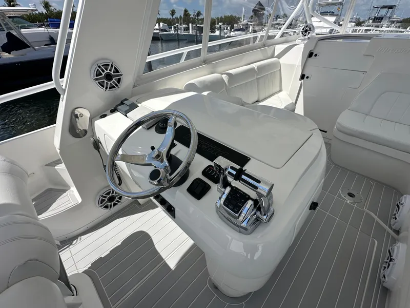 Slide: The Image of 2008 Intrepid 390 Sport Yacht helm station with steering wheel and controls. - 6