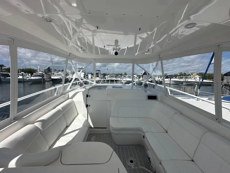 Slide: The Image of 2008 Intrepid 390 Sport Yacht interior with white seating and marina view. - 8