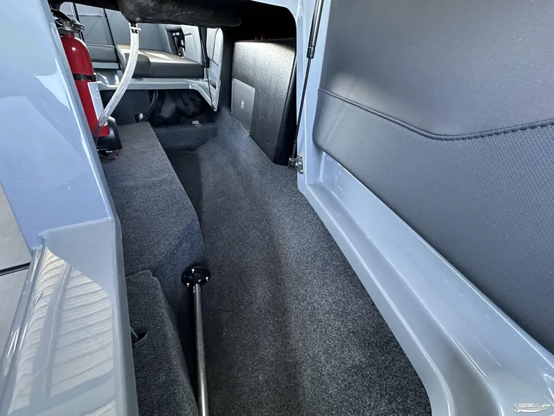 Slide: The Image of 2024 MasterCraft NXT21 interior storage compartment with fire extinguisher. - 7