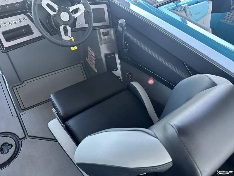 Slide: The Image of 2024 MasterCraft NXT21 boat interior with steering wheel and seating. - 8