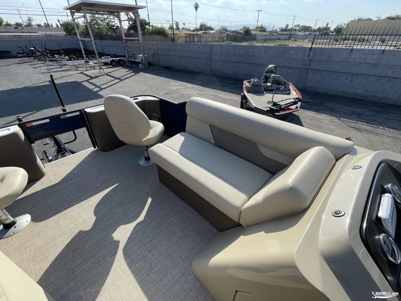 Slide: The Image of 2023 Crest 200 Classic Fish pontoon boat interior with seating and fishing equipment. - 10